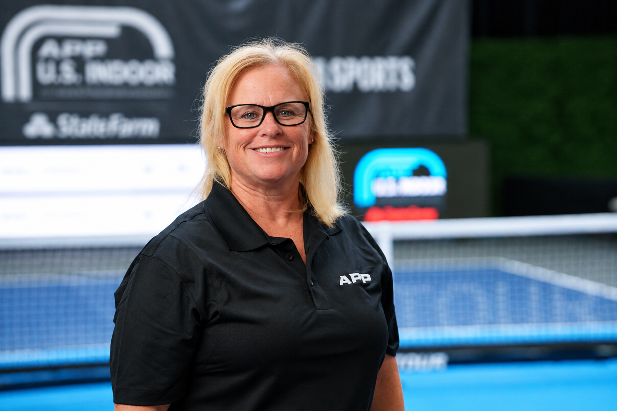 Melissa McCurley smiling in a black APP polo shirt